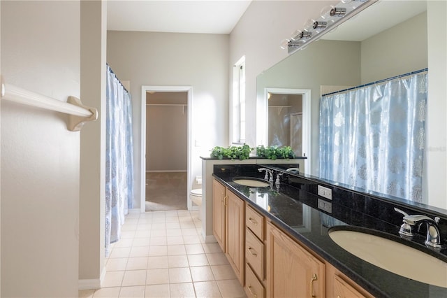 9159 Highland Ridge Way, Tampa, FL 33647 - bathroom featuring tile patterned flooring, double vanity, a sink, and toilet