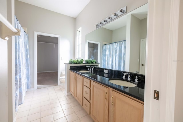 9159 Highland Ridge Way, Tampa, FL 33647 - bathroom featuring tile patterned floors, double vanity, a sink, and toilet