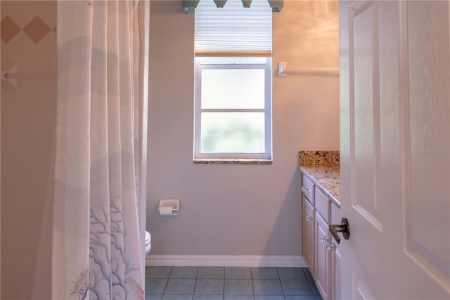 9159 Highland Ridge Way, Tampa, FL 33647 - bathroom with vanity, toilet, curtained shower, tile patterned floors, and baseboards