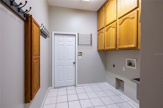 9159 Highland Ridge Way, Tampa, FL 33647 - laundry area featuring hookup for an electric dryer, baseboards, light tile patterned floors, hookup for a washing machine, and cabinet space