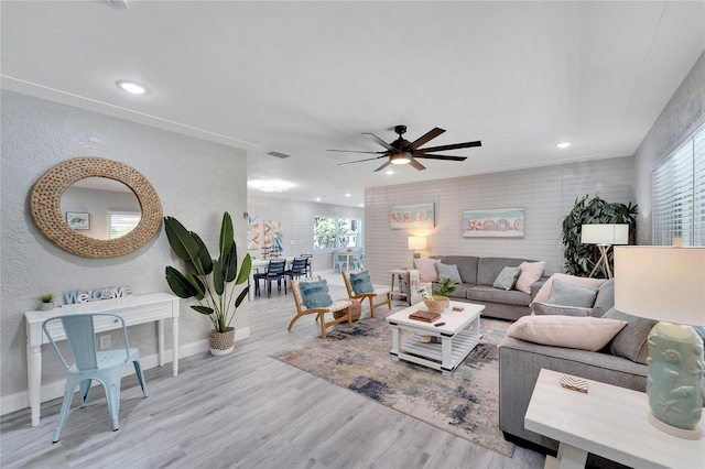 living area featuring ceiling fan, baseboards, wood finished floors, and recessed lighting