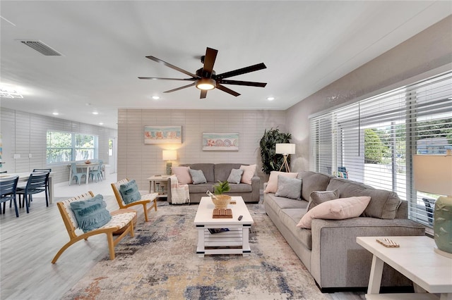 living area featuring wood finished floors, visible vents, recessed lighting, and ceiling fan