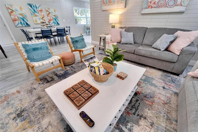living area featuring tile walls and wood finished floors