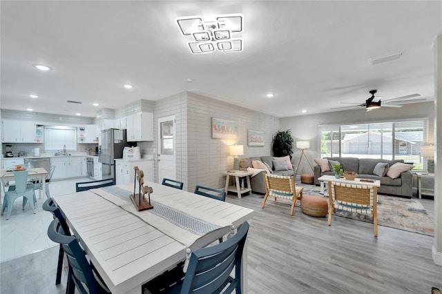 dining area featuring a ceiling fan, light wood-style floors, visible vents, and recessed lighting