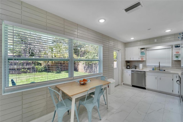kitchen featuring open shelves, a sink, dishwasher, marble finish floor, and visible vents