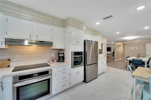 kitchen with stainless steel appliances, visible vents, recessed lighting, light countertops, and under cabinet range hood