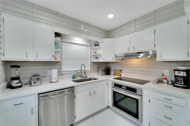 kitchen with under cabinet range hood, open shelves, backsplash, a sink, and appliances with stainless steel finishes