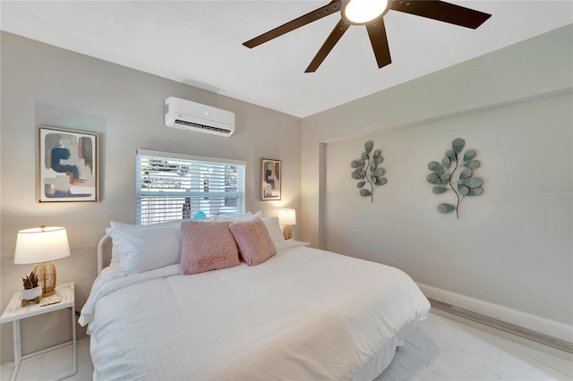 bedroom with baseboards, marble finish floor, ceiling fan, and a wall mounted air conditioner