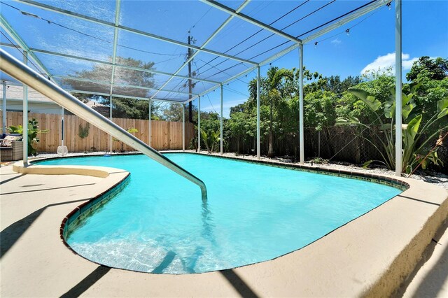 view of pool featuring a patio area, a fenced in pool, a lanai, and a fenced backyard