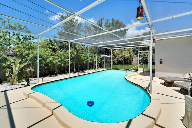 view of swimming pool featuring a fenced backyard, a patio area, a fenced in pool, and glass enclosure