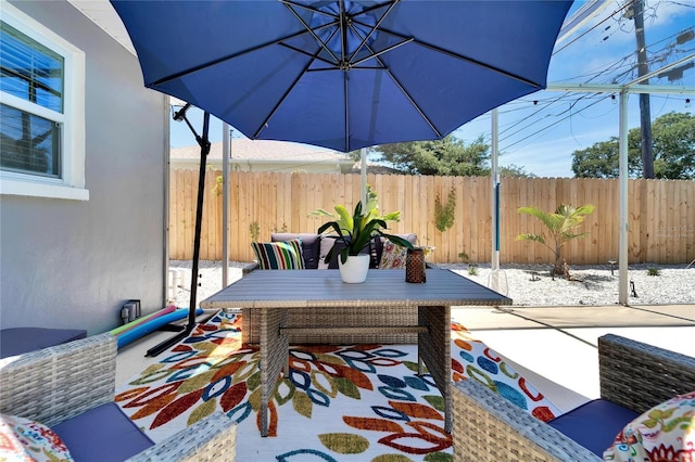 view of patio featuring fence
