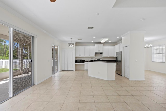 20123 Bay Cedar Ave, Tampa, FL 33647 - kitchen with visible vents, freestanding refrigerator, a chandelier, and ornamental molding