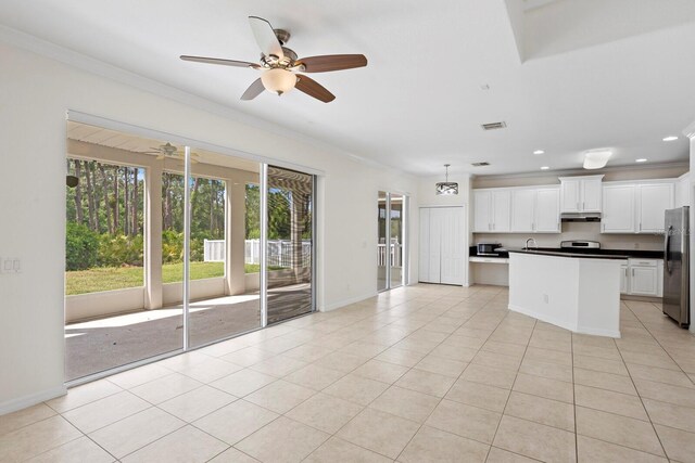 20123 Bay Cedar Ave, Tampa, FL 33647 - interior space with under cabinet range hood, a ceiling fan, freestanding refrigerator, and crown molding