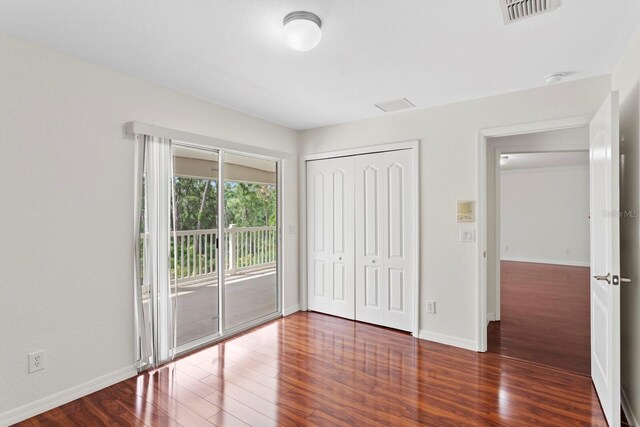 20123 Bay Cedar Ave, Tampa, FL 33647 - unfurnished bedroom with wood finished floors, a closet, baseboards, access to outside, and visible vents