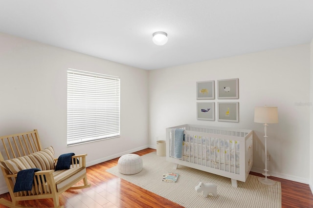 20123 Bay Cedar Ave, Tampa, FL 33647 - bedroom featuring baseboards, wood finished floors, and a nursery area