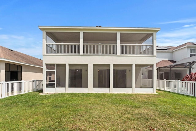 20123 Bay Cedar Ave, Tampa, FL 33647 - back of house with a balcony, a lawn, fence, stucco siding, and a sunroom