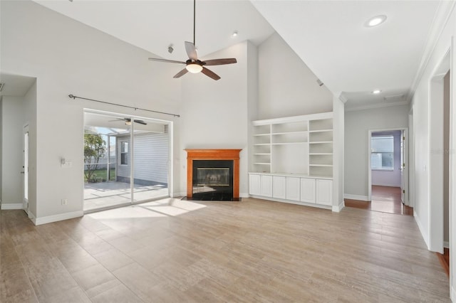 6518 Paw Pl, Land O Lakes, FL 34639 - unfurnished living room with crown molding, ceiling fan, a fireplace with flush hearth, and baseboards