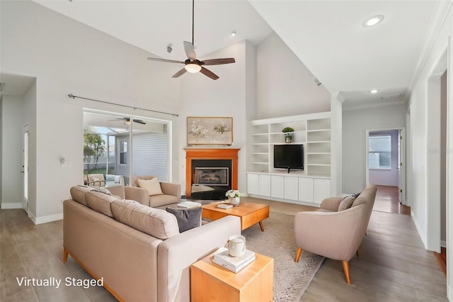 6518 Paw Pl, Land O Lakes, FL 34639 - living area with baseboards, wood finished floors, a ceiling fan, and plenty of natural light