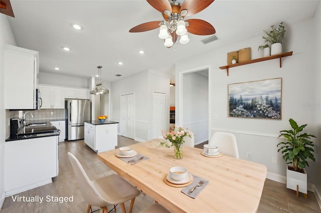 6518 Paw Pl, Land O Lakes, FL 34639 - dining room with light wood-style floors, ceiling fan, visible vents, baseboards, and recessed lighting