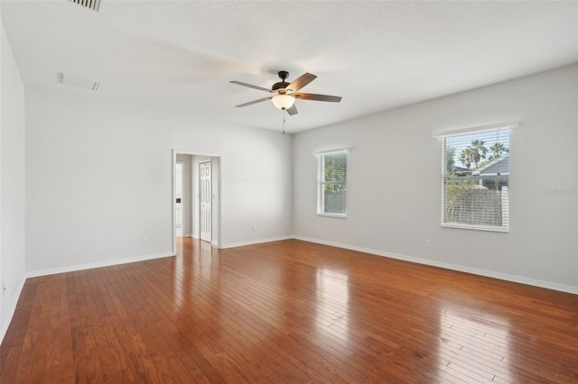 6518 Paw Pl, Land O Lakes, FL 34639 - spare room featuring ceiling fan, a healthy amount of sunlight, baseboards, and wood-type flooring