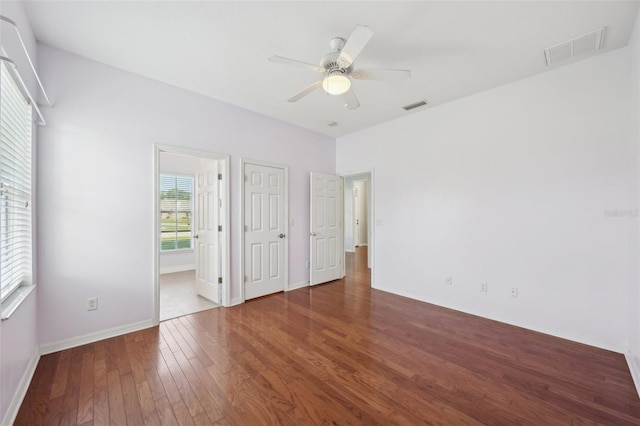 6518 Paw Pl, Land O Lakes, FL 34639 - unfurnished bedroom with visible vents, ceiling fan, hardwood / wood-style flooring, and baseboards