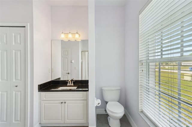 6518 Paw Pl, Land O Lakes, FL 34639 - bathroom featuring baseboards, toilet, a closet, and vanity