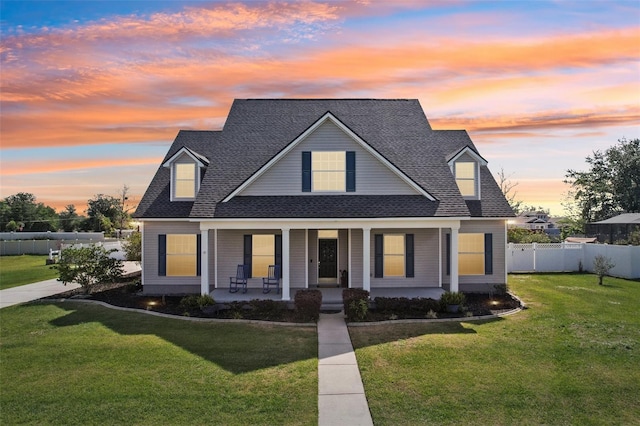 6518 Paw Pl, Land O Lakes, FL 34639 - bungalow featuring fence, roof with shingles, covered porch, and a front lawn