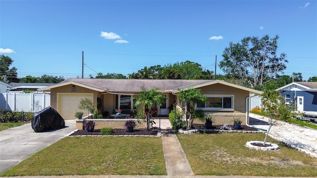 5931 33rd Ave N, Saint Petersburg, FL 33710 - single story home with an attached garage, fence, a front yard, and concrete driveway