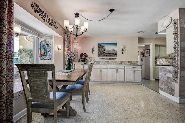 5931 33rd Ave N, Saint Petersburg, FL 33710 - dining space featuring visible vents, baseboards, an inviting chandelier, and light speckled floor