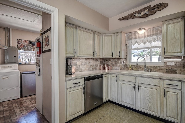 5931 33rd Ave N, Saint Petersburg, FL 33710 - kitchen with stainless steel dishwasher, a sink, electric panel, light countertops, and washer / clothes dryer