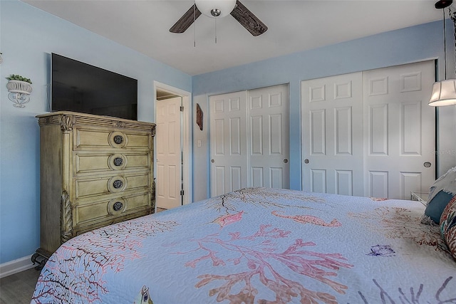 5931 33rd Ave N, Saint Petersburg, FL 33710 - bedroom with multiple closets, baseboards, ceiling fan, and dark wood-style floors