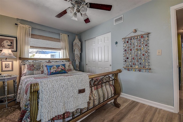 5931 33rd Ave N, Saint Petersburg, FL 33710 - bedroom featuring wood finished floors, visible vents, a closet, baseboards, and ceiling fan