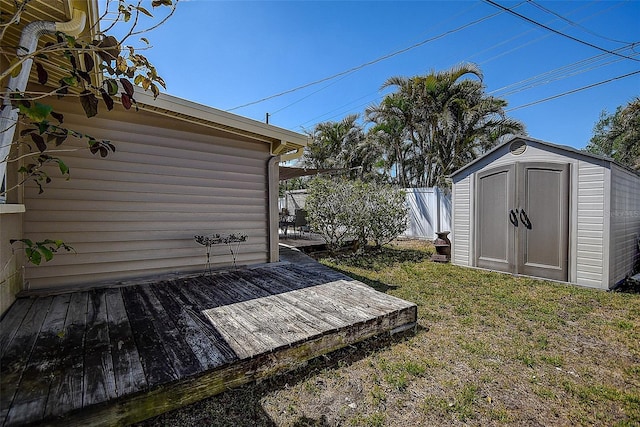 5931 33rd Ave N, Saint Petersburg, FL 33710 - view of yard featuring a wooden deck, a storage unit, fence, and an outdoor structure