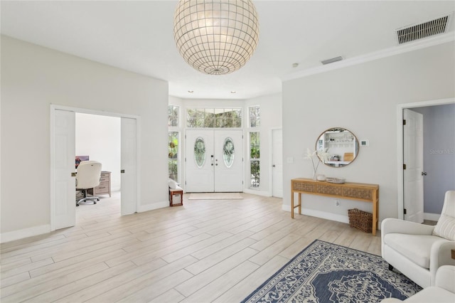 entryway with light wood-style floors, visible vents, and baseboards