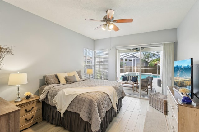 bedroom featuring light wood-style floors, a sunroom, ceiling fan, and access to outside