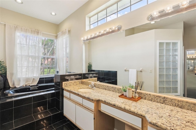 bathroom with recessed lighting, plenty of natural light, tile patterned floors, and vanity