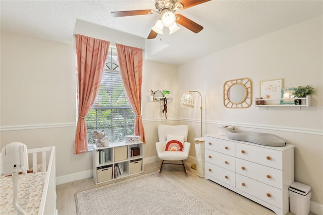 bedroom with ceiling fan, baseboards, and wood finished floors