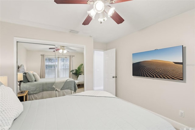 bedroom with baseboards, a ceiling fan, visible vents, and a closet