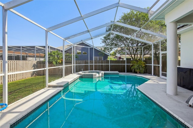 view of swimming pool with a fenced backyard, a patio area, a pool with connected hot tub, and a lawn