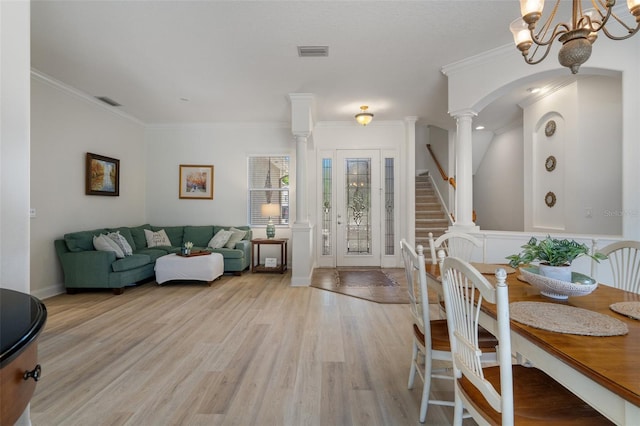 27318 Sora Blvd, Wesley Chapel, FL 33544 - interior space with an inviting chandelier, crown molding, visible vents, ornate columns, and wood finished floors