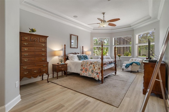 27318 Sora Blvd, Wesley Chapel, FL 33544 - bedroom with crown molding, light wood-type flooring, a raised ceiling, and baseboards