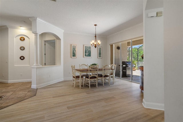 27318 Sora Blvd, Wesley Chapel, FL 33544 - dining room featuring ornamental molding, light wood-style flooring, an inviting chandelier, and baseboards