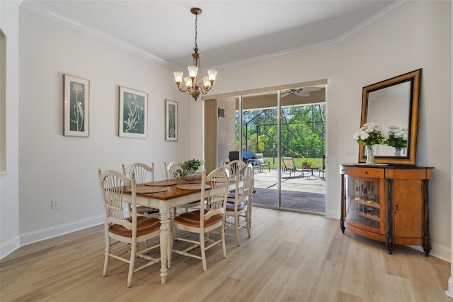 27318 Sora Blvd, Wesley Chapel, FL 33544 - dining space with crown molding, light wood finished floors, baseboards, and an inviting chandelier