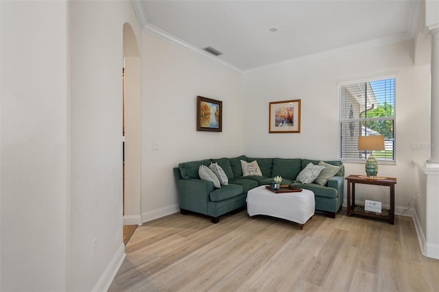 27318 Sora Blvd, Wesley Chapel, FL 33544 - living area with arched walkways, crown molding, visible vents, and light wood-type flooring