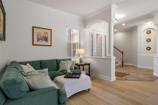 27318 Sora Blvd, Wesley Chapel, FL 33544 - living room featuring crown molding, light wood-type flooring, decorative columns, and baseboards