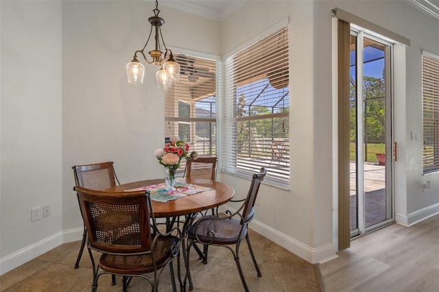 27318 Sora Blvd, Wesley Chapel, FL 33544 - dining room featuring a notable chandelier, ornamental molding, and baseboards