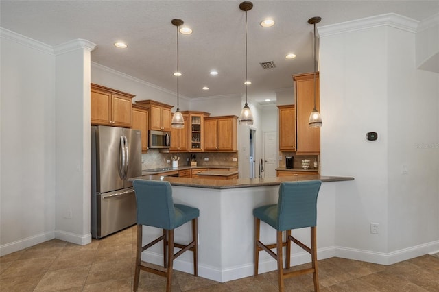 27318 Sora Blvd, Wesley Chapel, FL 33544 - kitchen with stainless steel appliances, visible vents, brown cabinetry, and backsplash