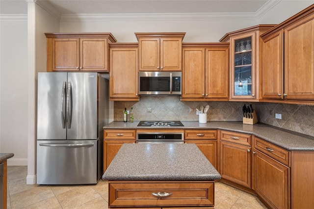 27318 Sora Blvd, Wesley Chapel, FL 33544 - kitchen with stainless steel appliances, ornamental molding, light tile patterned floors, decorative backsplash, and brown cabinetry