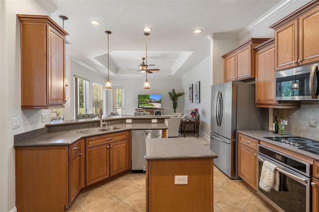 27318 Sora Blvd, Wesley Chapel, FL 33544 - kitchen with a tray ceiling, ceiling fan, stainless steel appliances, decorative backsplash, and a sink
