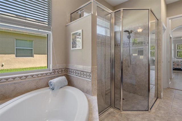 27318 Sora Blvd, Wesley Chapel, FL 33544 - bathroom with tile patterned flooring, a stall shower, and a garden tub